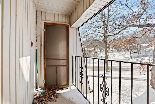 view of snow covered back of property