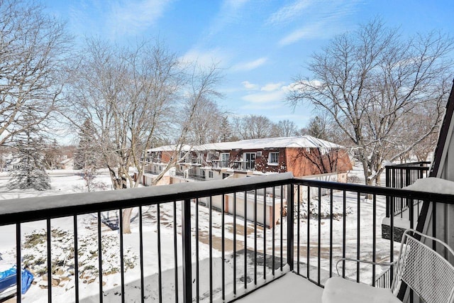 view of snow covered back of property