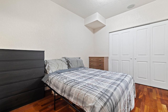 bedroom featuring a closet and dark hardwood / wood-style floors