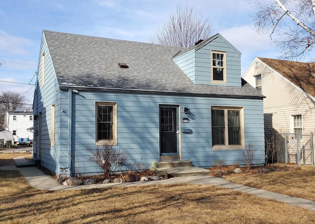 new england style home with a front yard