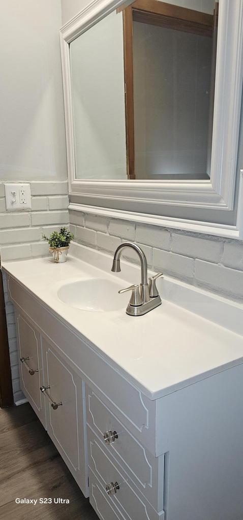 bathroom with vanity and wood-type flooring