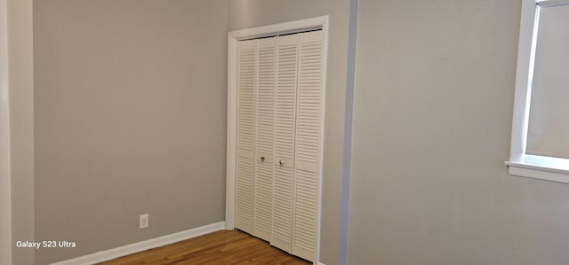 unfurnished bedroom with hardwood / wood-style floors and a closet