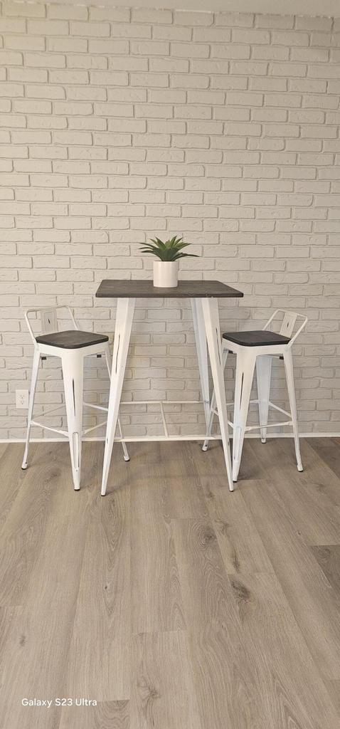 unfurnished dining area with brick wall and hardwood / wood-style floors