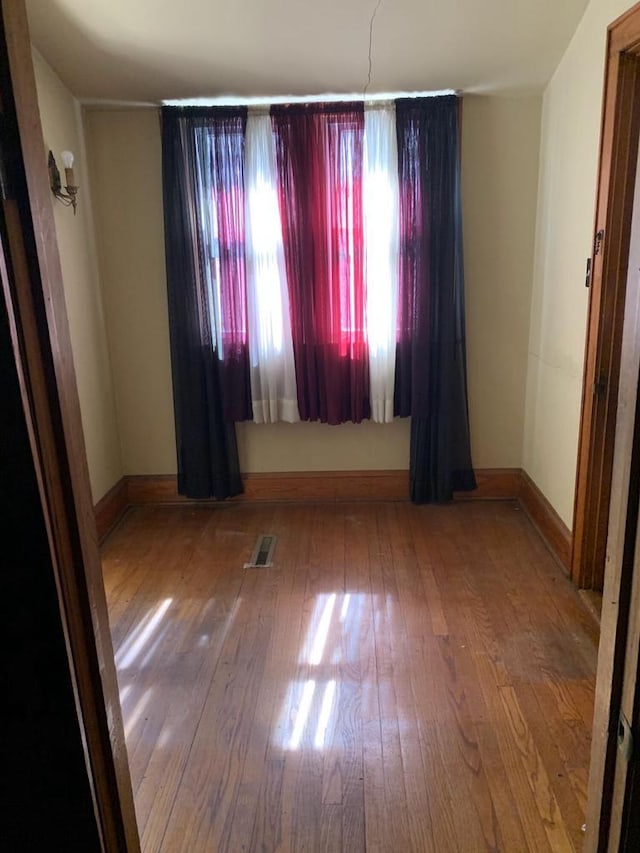 unfurnished room featuring hardwood / wood-style flooring