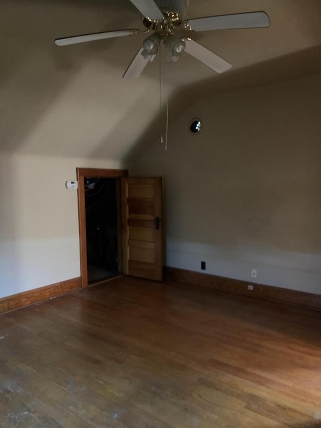 additional living space featuring hardwood / wood-style flooring, vaulted ceiling, and ceiling fan