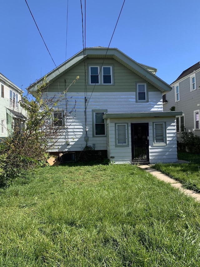 rear view of house with a yard