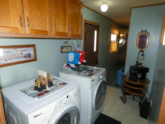 washroom featuring cabinets and independent washer and dryer