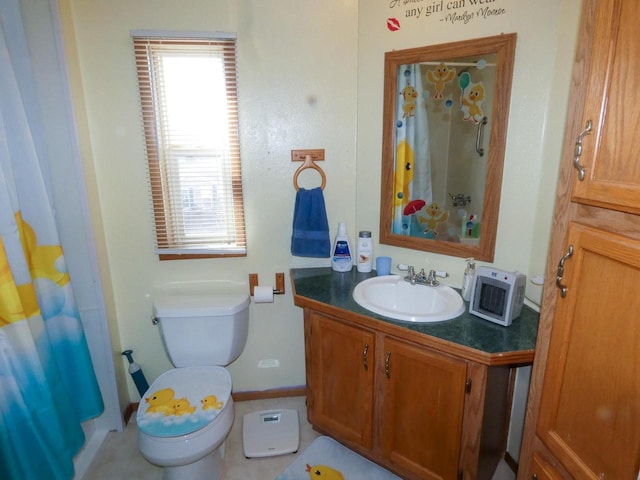 bathroom featuring vanity, curtained shower, and toilet