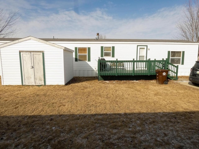 rear view of property with a lawn and a deck