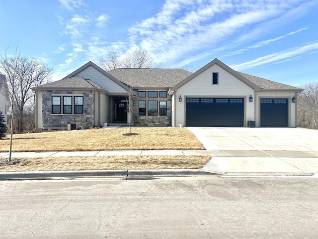 1452 Serenity Ct, Sun Prairie, WI 53590 - view of front of home featuring stone siding, driveway, roof with shingles, and a garage