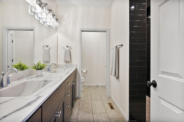 1452 Serenity Ct, Sun Prairie, WI 53590 - full bath featuring double vanity, toilet, a tile shower, and a sink