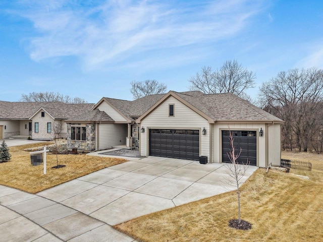 1452 Serenity Ct, Sun Prairie, WI 53590 - ranch-style home featuring roof with shingles, an attached garage, concrete driveway, and a front yard
