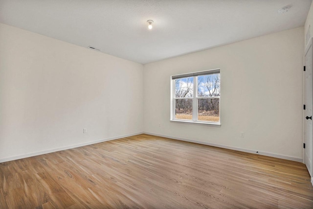 1452 Serenity Ct, Sun Prairie, WI 53590 - spare room featuring visible vents, light wood finished floors, and baseboards
