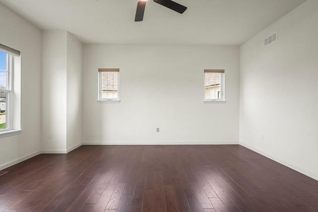 1452 Serenity Ct, Sun Prairie, WI 53590 - spare room featuring visible vents, a ceiling fan, dark wood-style flooring, and a healthy amount of sunlight