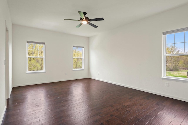 1452 Serenity Ct, Sun Prairie, WI 53590 - unfurnished room featuring a ceiling fan, baseboards, dark wood finished floors, and a wealth of natural light