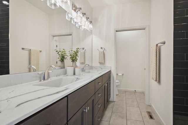 1452 Serenity Ct, Sun Prairie, WI 53590 - full bath featuring double vanity, toilet, tile patterned floors, and a sink