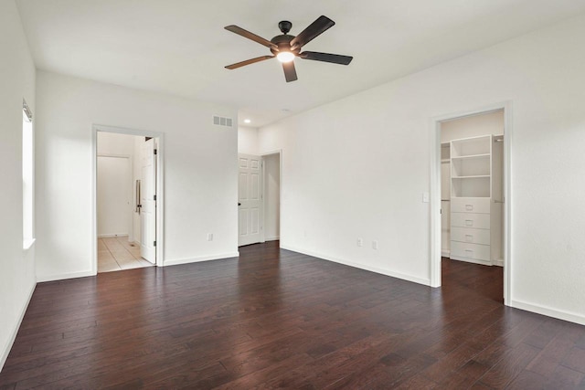1452 Serenity Ct, Sun Prairie, WI 53590 - unfurnished bedroom with a spacious closet, baseboards, hardwood / wood-style flooring, and visible vents