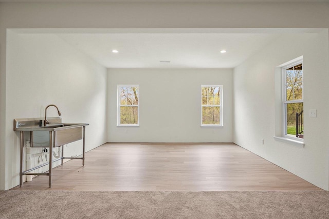 1452 Serenity Ct, Sun Prairie, WI 53590 - spare room featuring a healthy amount of sunlight, recessed lighting, and wood finished floors