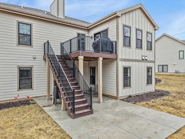 1452 Serenity Ct, Sun Prairie, WI 53590 - rear view of property featuring a deck, a chimney, stairs, board and batten siding, and a patio area