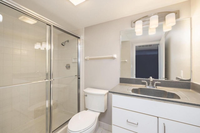 bathroom featuring toilet, visible vents, a shower stall, and vanity