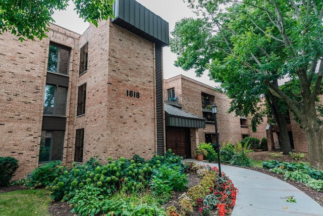 view of building exterior featuring a garage and concrete driveway