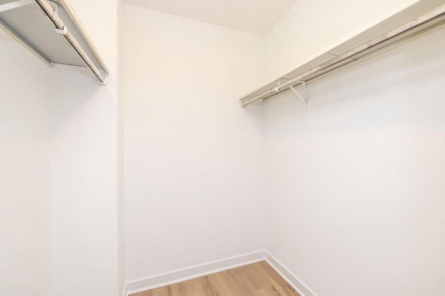 spacious closet with wood finished floors