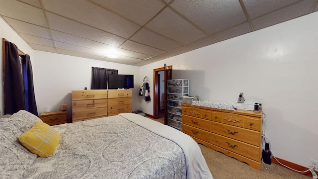 carpeted bedroom with a paneled ceiling