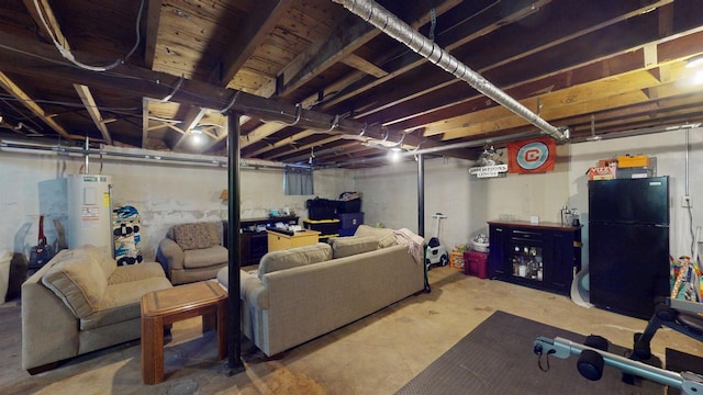 basement with black fridge and water heater