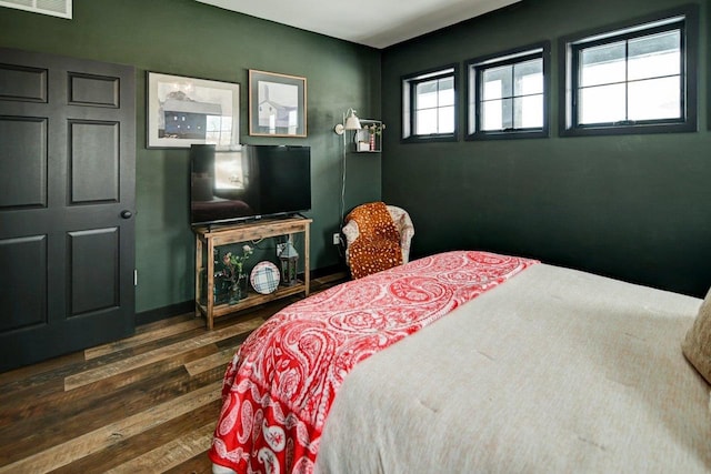 bedroom with visible vents and wood finished floors