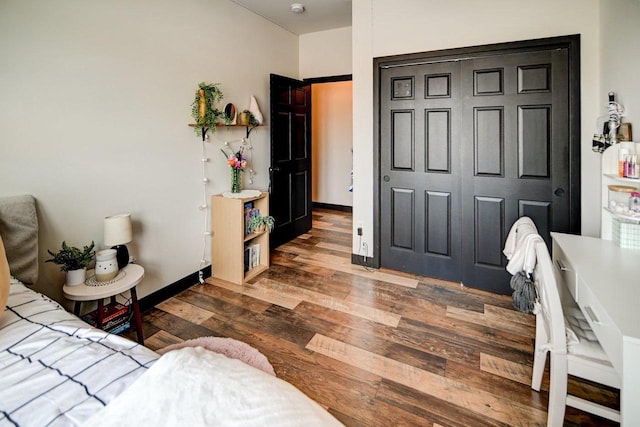 bedroom featuring baseboards and wood finished floors