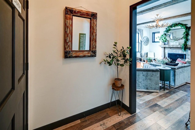 corridor featuring baseboards and dark wood finished floors