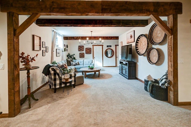 living area featuring light carpet, beamed ceiling, a notable chandelier, and baseboards