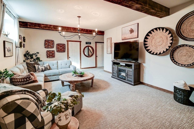 carpeted living room with a notable chandelier, baseboards, and beam ceiling