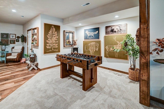 recreation room featuring baseboards, visible vents, wood finished floors, and recessed lighting