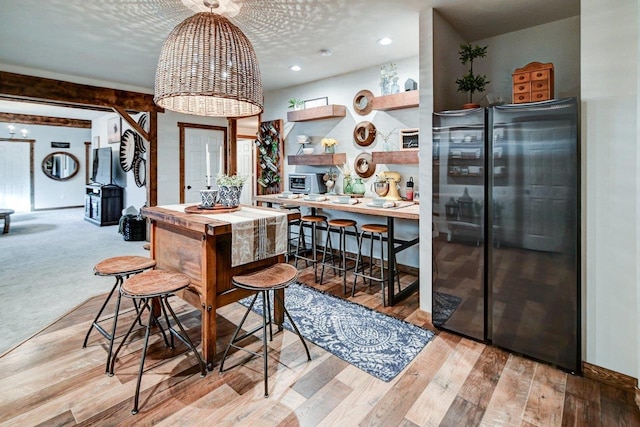 bar with baseboards, wood finished floors, freestanding refrigerator, a textured ceiling, and recessed lighting