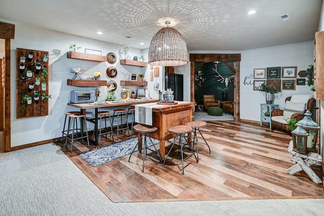 dining area with light wood-type flooring, baseboards, and recessed lighting