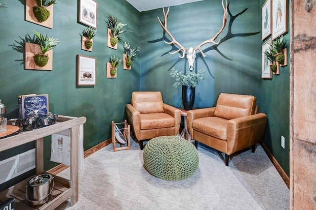 living area featuring carpet floors and baseboards