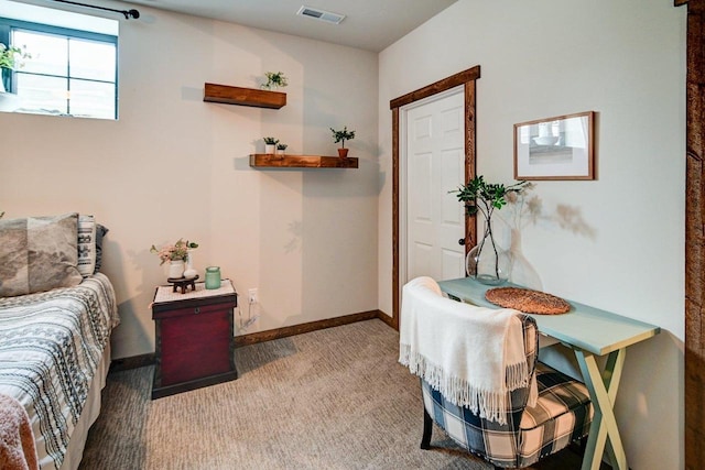 carpeted bedroom featuring baseboards and visible vents