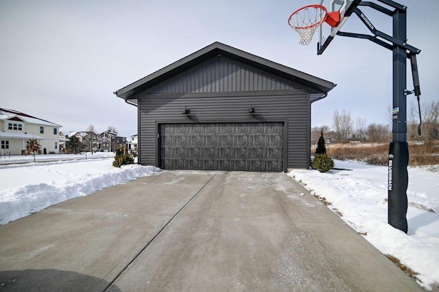 snow covered garage with a garage