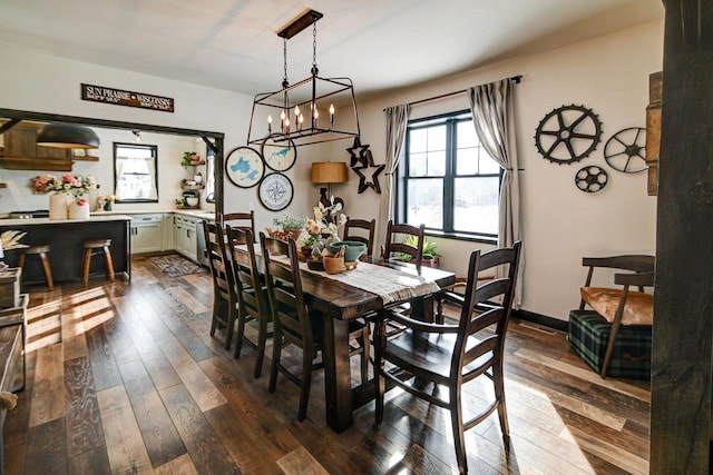 dining room featuring dark wood finished floors and baseboards