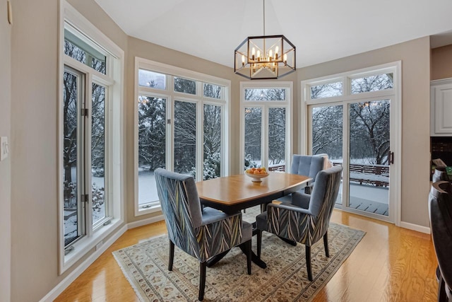 dining room with a notable chandelier and light hardwood / wood-style floors