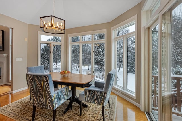 dining space featuring an inviting chandelier and light hardwood / wood-style floors