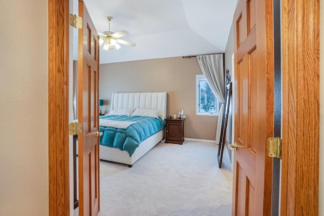 bedroom with ceiling fan, vaulted ceiling, and light carpet