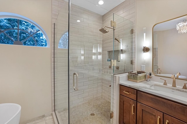 bathroom with vanity and separate shower and tub