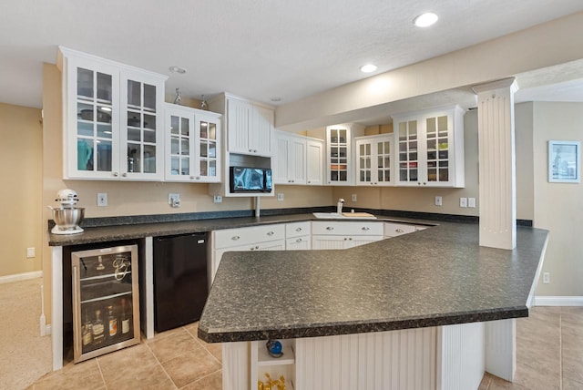 kitchen with white cabinets, fridge, sink, and beverage cooler