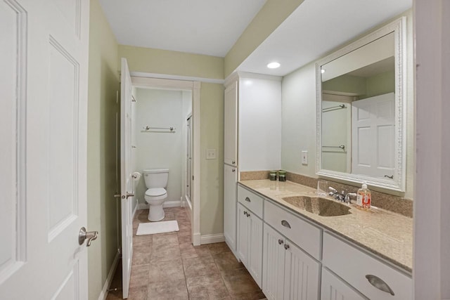 bathroom featuring vanity, tile patterned flooring, and toilet