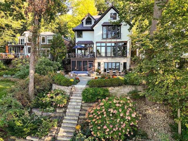 back of house with a patio, stairway, and stucco siding