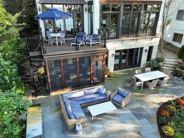 view of patio / terrace with outdoor dining area, an outdoor hangout area, stairs, and french doors