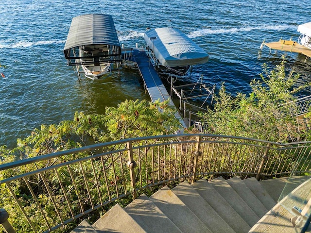 dock area with a water view and boat lift