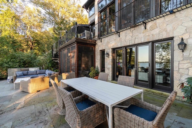 view of patio / terrace featuring an outdoor hangout area, a balcony, and outdoor dining space